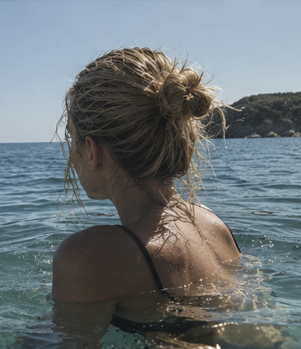 Woman in the ocean seen from behind